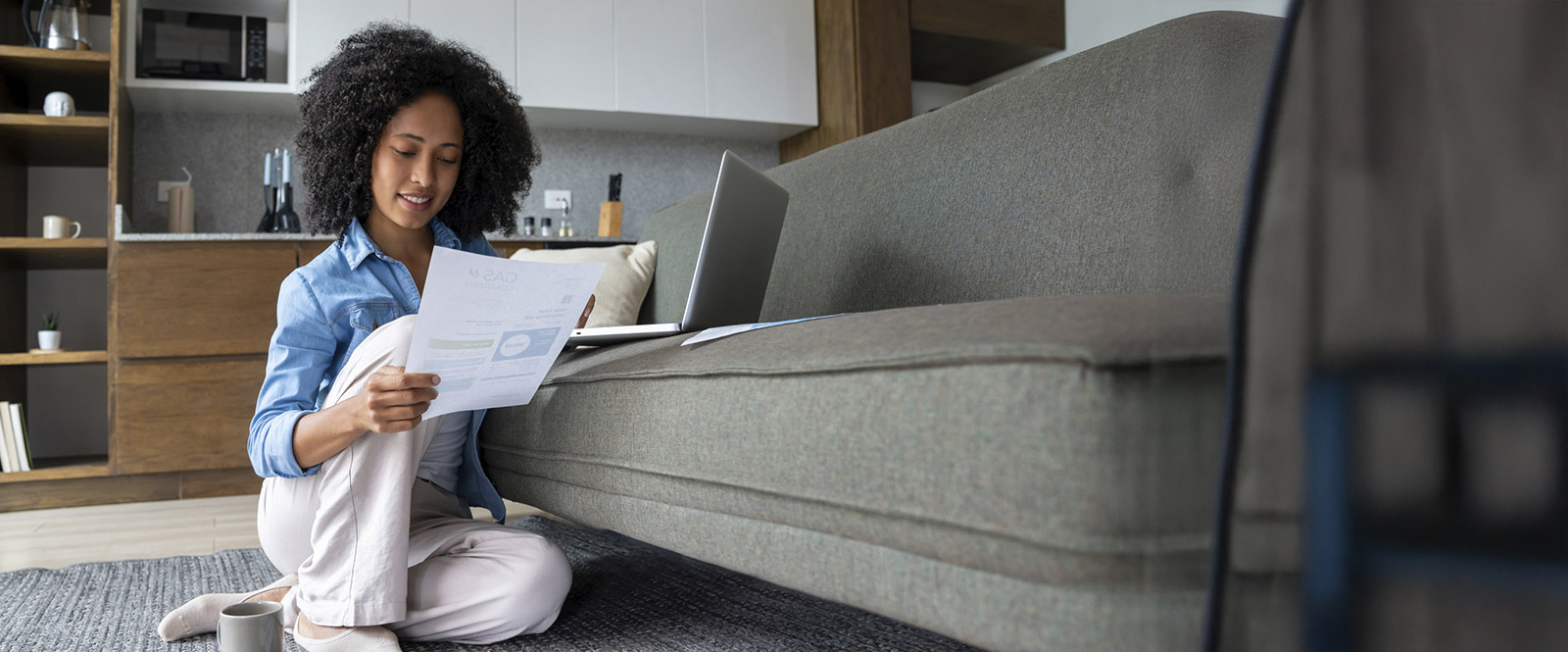 Woman with laptop checking her finances.